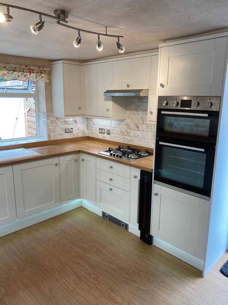 New Kitchen Fitted with white doors and a wooden work surface in Tingley by Chris Ward Plumbing & Heating